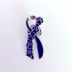 A black and silver ribbon of paw prints pin